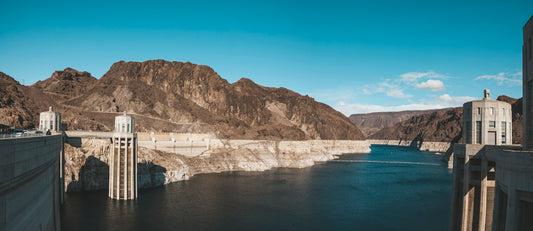 gray dam near mountains during day