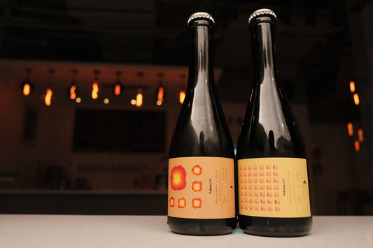 two bottles of wine sitting on top of a table